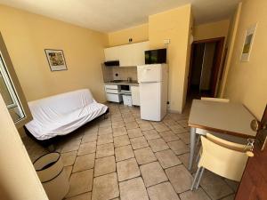 a small kitchen with a bed and a refrigerator at Residence IL BORGO 35 in Tortoreto Lido