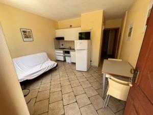 a small kitchen with a bed and a refrigerator at Residence IL BORGO 35 in Tortoreto Lido