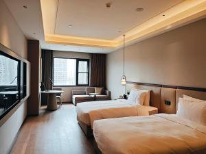 Rúm í herbergi á Xi'an Jinling Purple Mountain Hotel