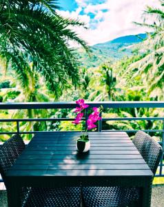 a table with a vase with a flower on it at AV Suites in Puerto Galera +289 photos