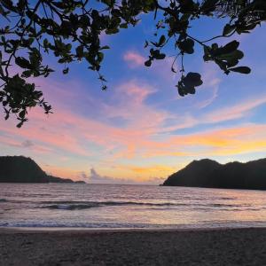 a view of the ocean at sunset at 1BR at Jacana B Pico de Loro in Nasugbu +3 photos