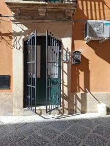 a gate on the side of a building at La Casetta dei Paceri in Syracuse