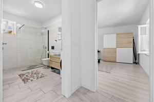 a white bathroom with a toilet and a sink at Lara Holiday Home in Kanfanar +27 photos