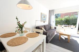 a living room with two tables and a couch at Beachhouse in Langeoog