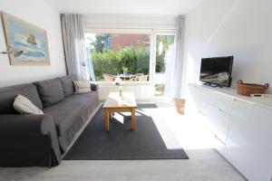a living room with a couch and a table at Beachhouse in Langeoog