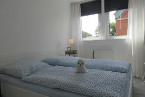 a bed with a white ghost toy on top of it at Beachhouse in Langeoog
