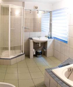 a bathroom with a sink and a shower at Willa "Mazowsze" in Nałęczów