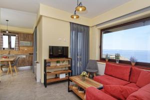 a living room with a red couch and a large window at Endless View in Mythimna