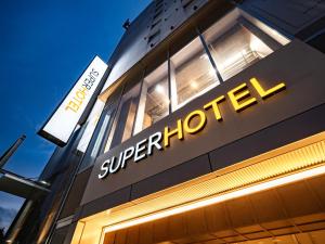 a store sign on the side of a building at Super Hotel Kyoto Shijokawaramachi in Kyoto +121 photos