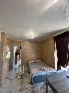 A bed or beds in a room at Dracena Guesthouse