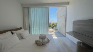 a bedroom with a bed with a stuffed animal on it at Vivo Mare 3 Bedroom Villas in Ayia Napa +34 photos