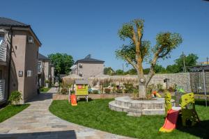 a yard with a tree and a playground at Complex Sea Star 2Mai in 2 Mai