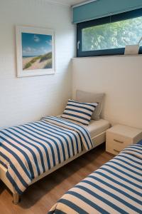 Postel nebo postele na pokoji v ubytování Ferienhaus LouJa