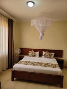 Postel nebo postele na pokoji v ubytování Patrinah Hotel