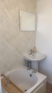 a white bathroom with a sink and a mirror at Mountain View, Brecon Beacons in Trefeinon Station