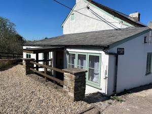 a white house with a wooden fence and a porch at Mountain View, Brecon Beacons in Trefeinon Station +4 photos