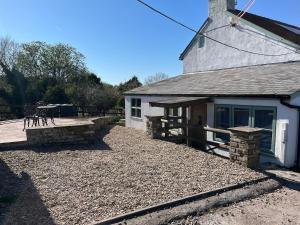 a building with a deck next to a house at Mountain View, Brecon Beacons in Trefeinon Station