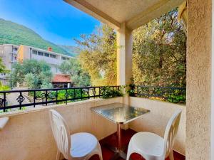 a balcony with a table and chairs and a view at The Four Fish in Petrovac na Moru