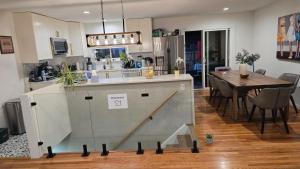 a kitchen and dining room with a table in it at Alanas house in Denver