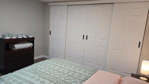a bedroom with two white closet doors and a bed at Alanas house in Denver