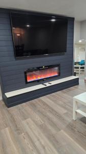 a fireplace with a tv on a wall at Alanas house in Denver
