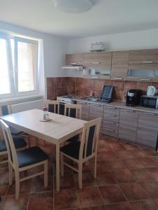 a kitchen with a table and chairs and a kitchen with a stove at U Poličky in Banská Bystrica