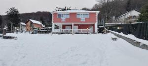 a house with a snow covered yard in front of it at Casa Greta La Dimora delle Fate in Villaggio Laceno