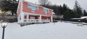 a red house in the snow with a street light at Casa Greta La Dimora delle Fate in Villaggio Laceno