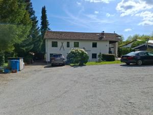 a white house with two cars parked in the driveway at Hochwald appartement in Bad Sachsa