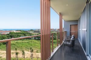 a balcony with a view of the ocean at 三亚海棠湾蔚蓝海湾公寓 in Sanya