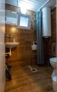 a bathroom with a sink and a toilet and a window at Alexander Bungalows in Shkorpilovtsi +69 photos