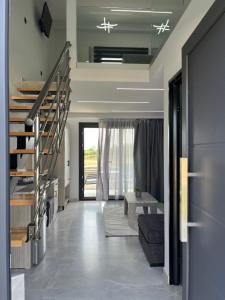 a hallway with a staircase and a living room at A Ponte Studios & Apartments in Sykia Chalkidikis