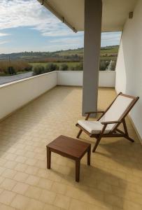una silla y un banco en el balcón en DreamLiving Vasto 1st, en Vasto