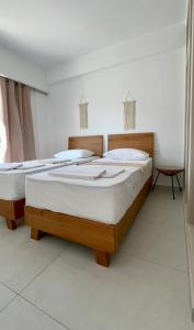 a bedroom with two beds in a room at Aenya Kythnos Villas in Kithnos