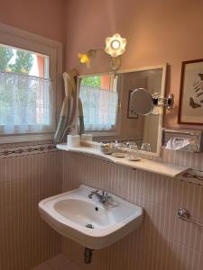 a bathroom with a sink and a mirror at Villa Solarola Country House in Castel Guelfo di Bologna +33 photos