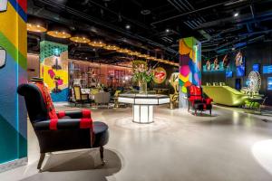 a showroom with chairs and tables and colorful walls at nhow London in London