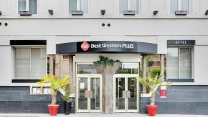 a best western plus building with palm trees in front of it at Best Western Plus Le Picardy Hotel & Spa in Saint-Quentin +143 photos