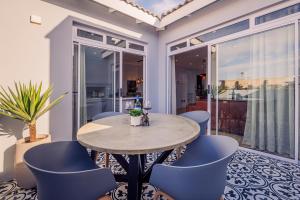 a dining room with a table and blue chairs at C Breeze 2 & 11 in Swakopmund