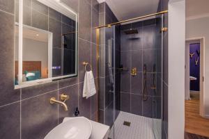 a bathroom with a shower with a sink and a toilet at C Breeze 2 & 11 in Swakopmund +42 photos