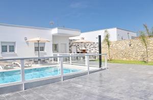 a villa with a swimming pool and a house at El Rincon de Samuel in Conil de la Frontera +21 photos