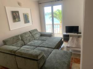 a living room with a couch and a table at un site calme et unique au Montenegro Loue des logements les pieds dans l eau avec plage privée en face de l ile Saint Marco in Tivat