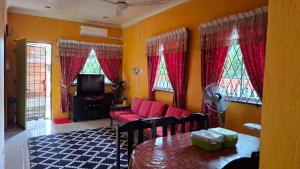 a living room with a couch and a table at Homestay 258 Beaufort in Beaufort