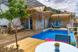 a villa with a swimming pool and a patio at Patika Villas in Kalkan