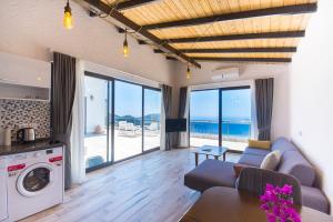 a living room with a couch and a table at Patika Villas in Kalkan