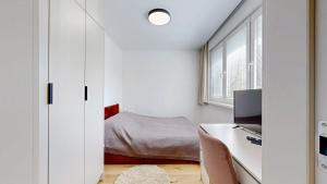 a small bedroom with a desk and a bed at FLEXIHOME sk - SNP 7 - four room apartment, AC, loggia in Košice