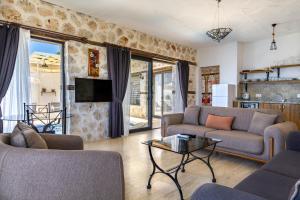 a living room with two couches and a tv at Patika Villas in Kalkan