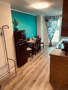a dining room with a table and a refrigerator at Apartament Turkusowy in Puck +9 photos