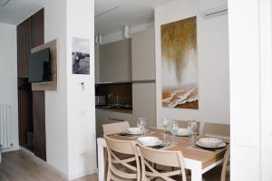 a dining room with a table and chairs at Como Charm Living Apartment Duomo in Como