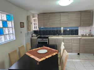 a kitchen with a table with a plate on it at 600 metres from the beach! in Nea Irakleia