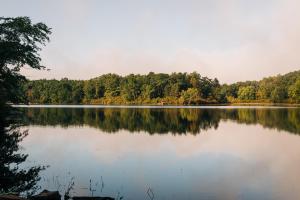 a large lake with trees reflecting on the water at Mohican Outdoor Center in Blairstown